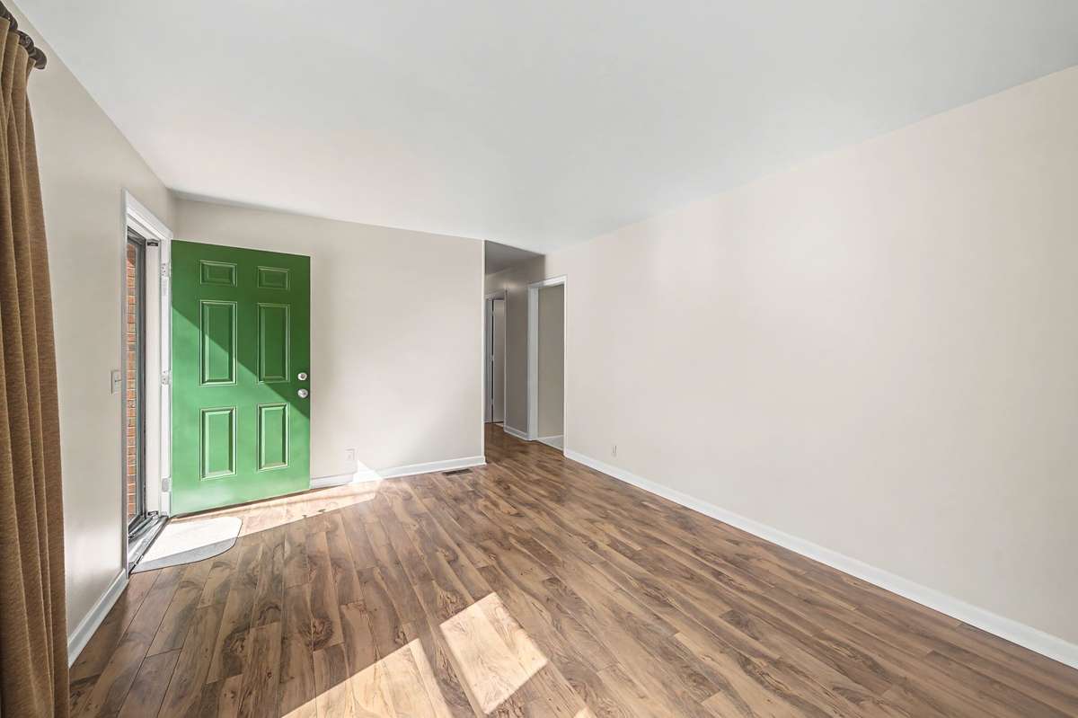 Hall way from the living room to the bedrooms and the kitchen to the right.