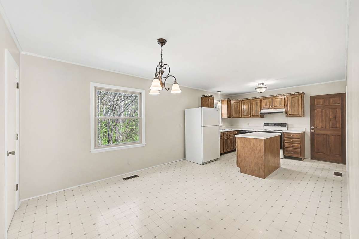 Big space for eating and cooking. New paint. New dishwasher. (No disposal or microwave.) Electric stove. Refrigerator stays.