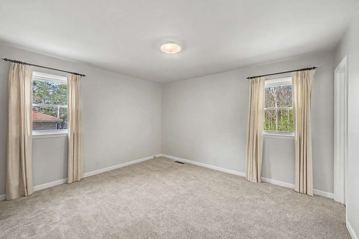 Primary bedroom in back corner with half bath.