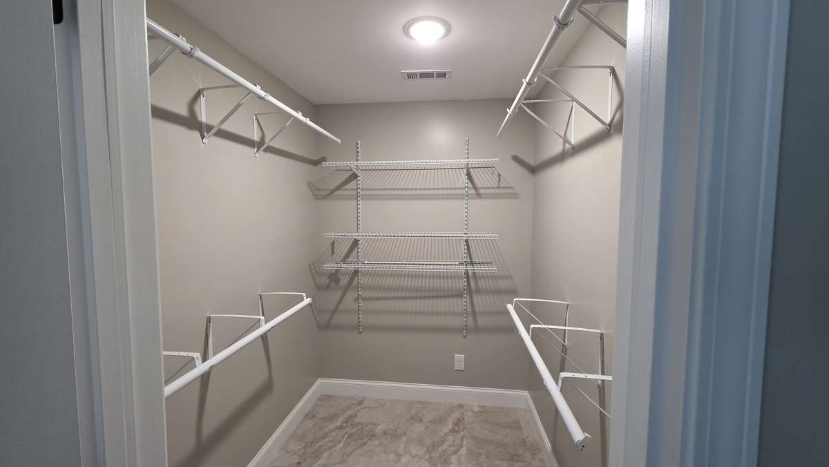 Primary bedroom walk-in closet