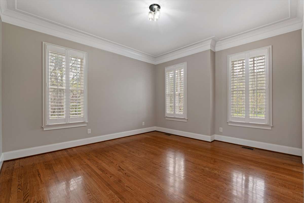 Room to the right as you enter--note the hardwood floors and planation shutters