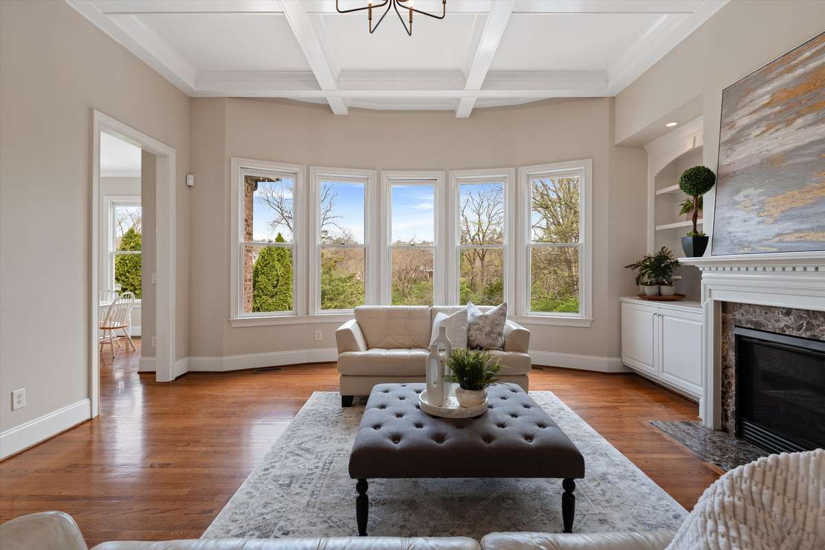 On the other side of the grand staircase, your gaze is directed to the wall of windows and the beautiful view in the living room