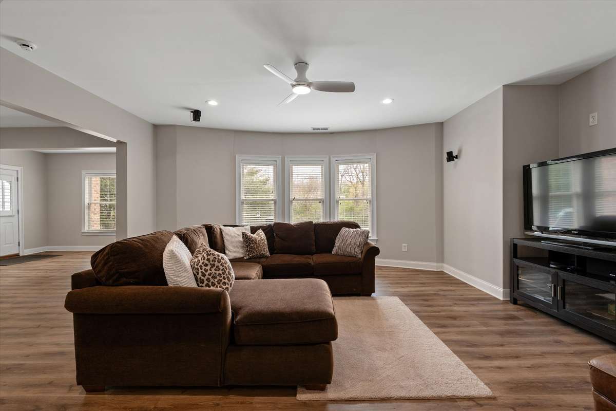 The basement has LVT flooring, tons of windows and multiple spaces for relaxing, living and entertaining