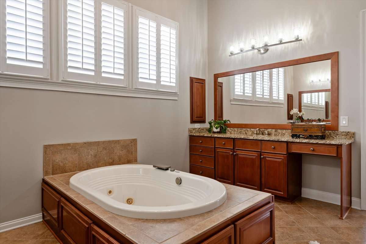 The primary bath is large with double vanities, tons of counter space and a spa like tub