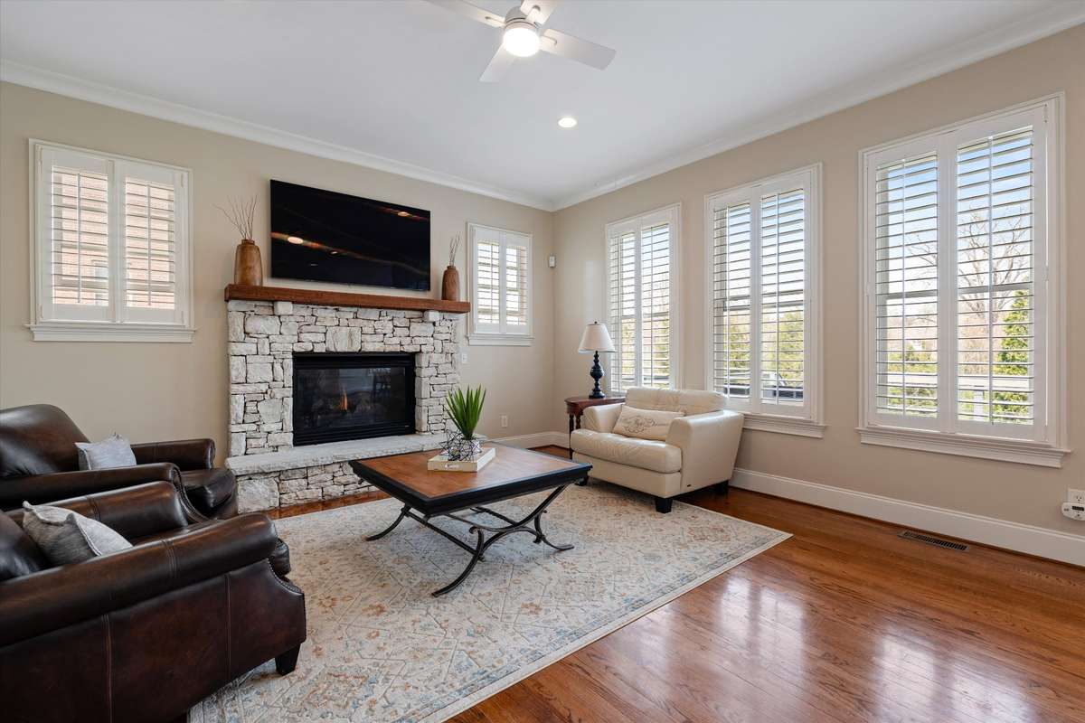 The keeping room off the kitchen is a lovely space to gather. A wall of windows, with plantation shutters keeps the natural light flowing in