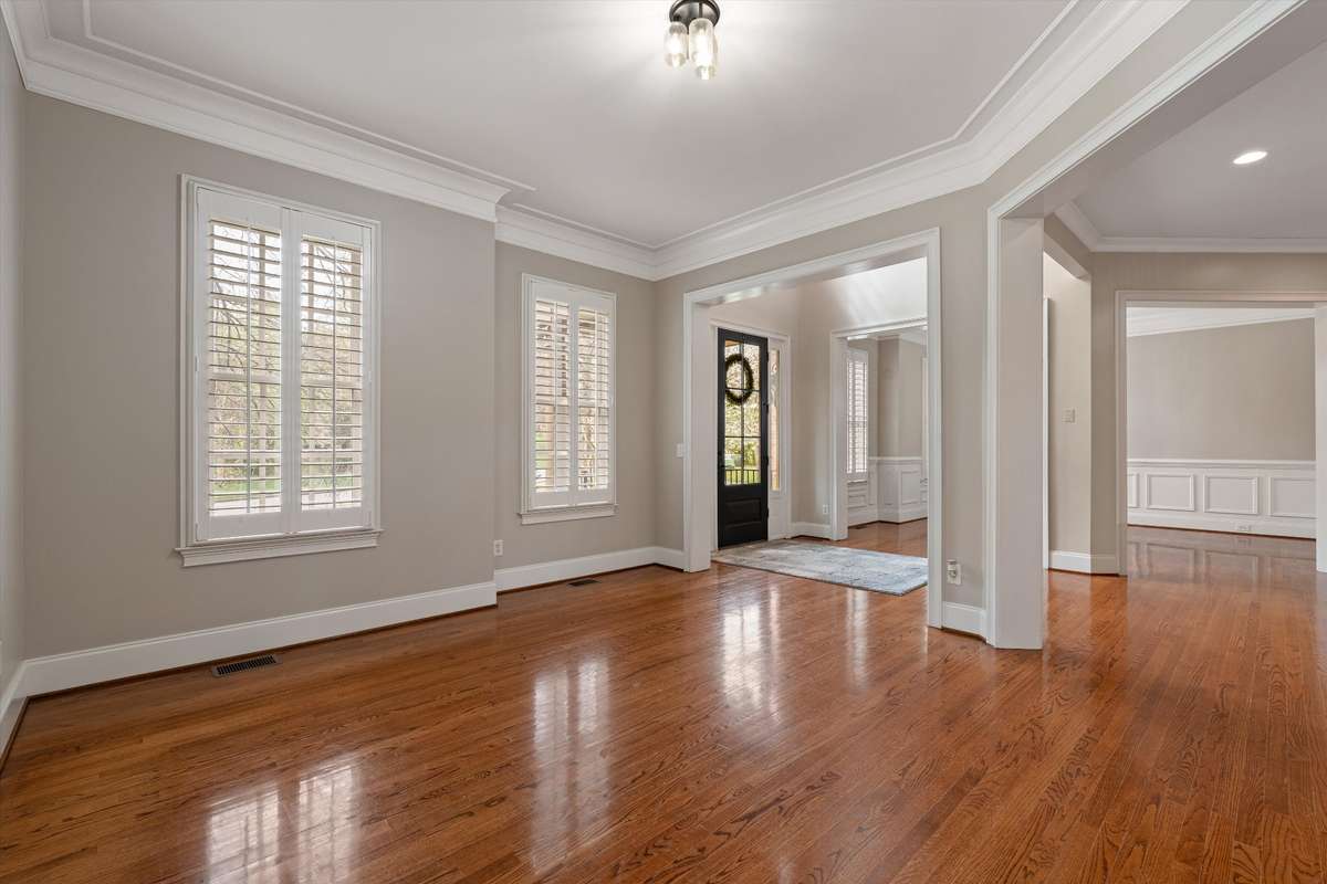 The space could remain open concept, or walls and French doors could be added for a more private office space or library