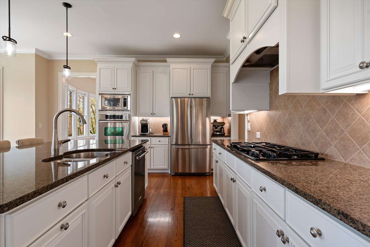 The kitchen boasts a gas stove, double ovens and tons of storage for all your kitchen essesntials