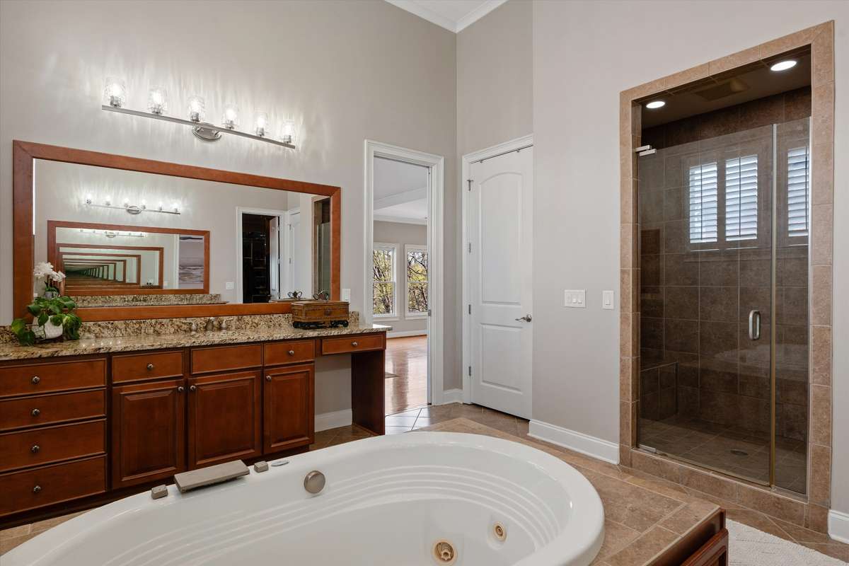 The primary bath has a walk in shower and to the left is a laundry