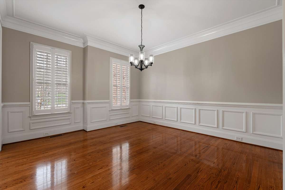 This lovely space is enhanced by wainscoting, hardwoods and large windows with plantation shutters
