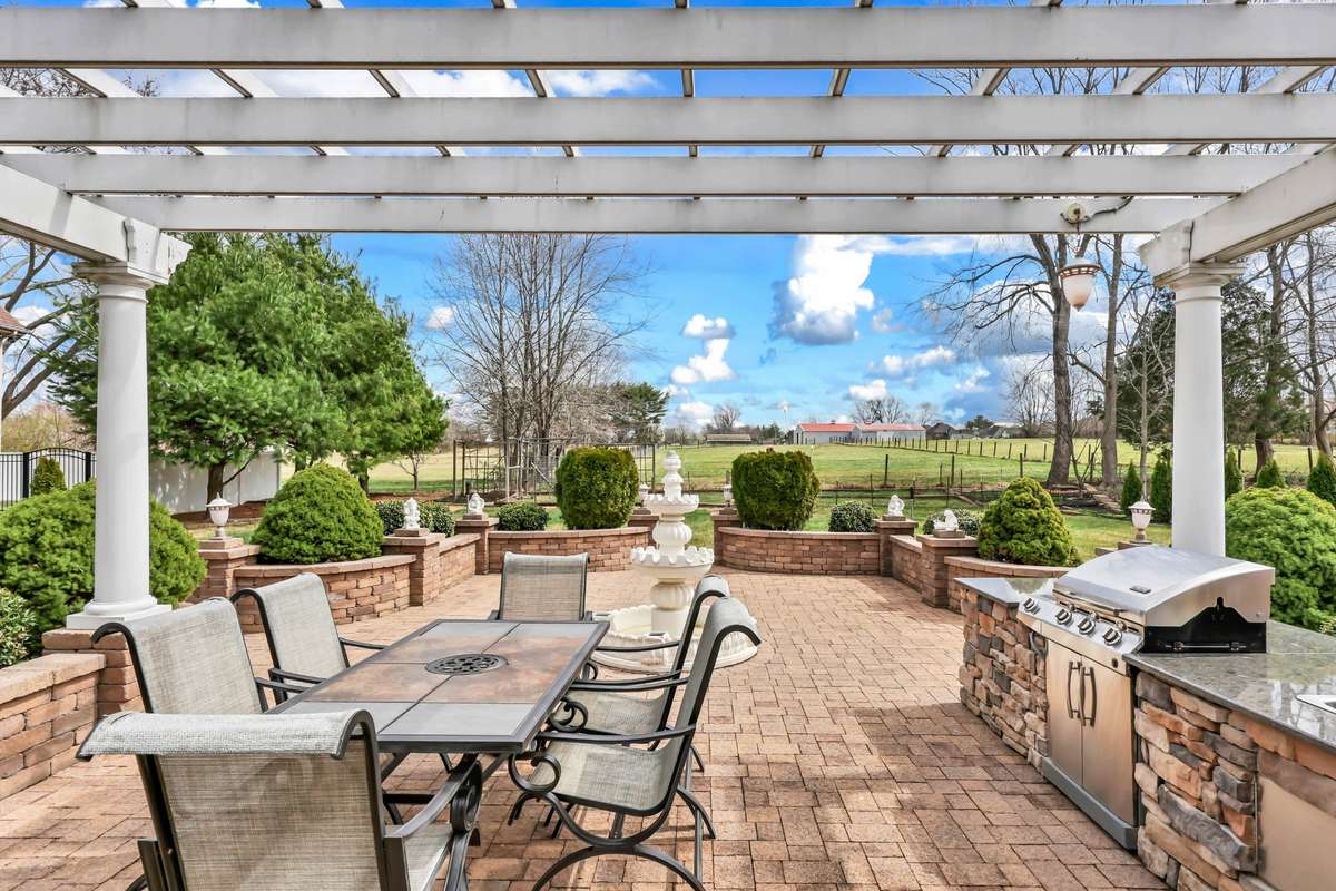 Incredible Backyard w/ a Stone Courtyard, Pergola, Fireplace & Outdoor Kitchen!