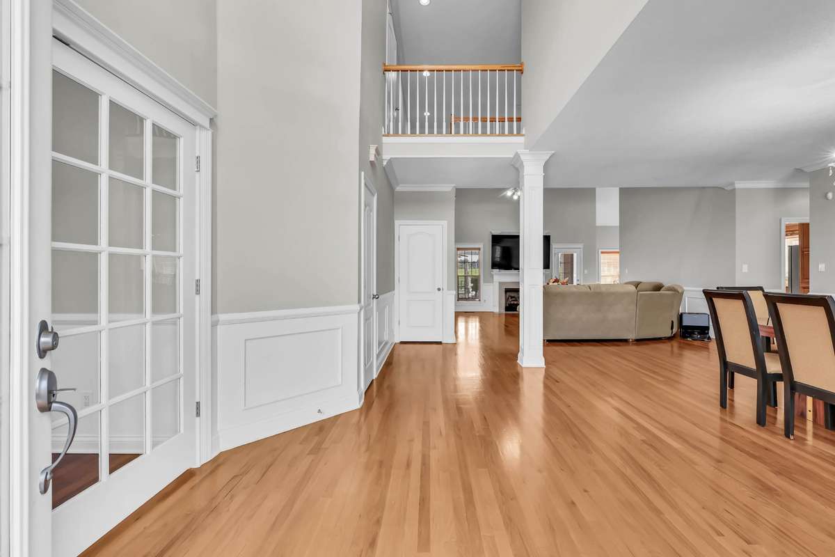 Freshly Polished Hardwood Flooring & Custom Trim Welcomes You In & Continues Throughout Downstairs!