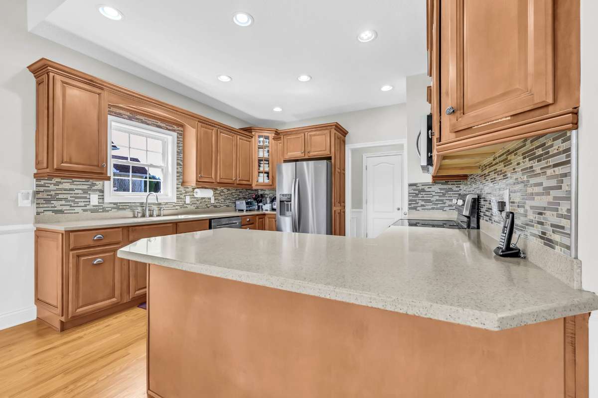 Beautiful Tile Backsplash, Stainless Steel Appliances & the Refrigerator Conveys!