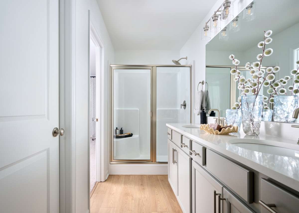 Walk in shower with a seat included comes in every home. Photo of our furnished model home - colors may vary, see sales for specifics
