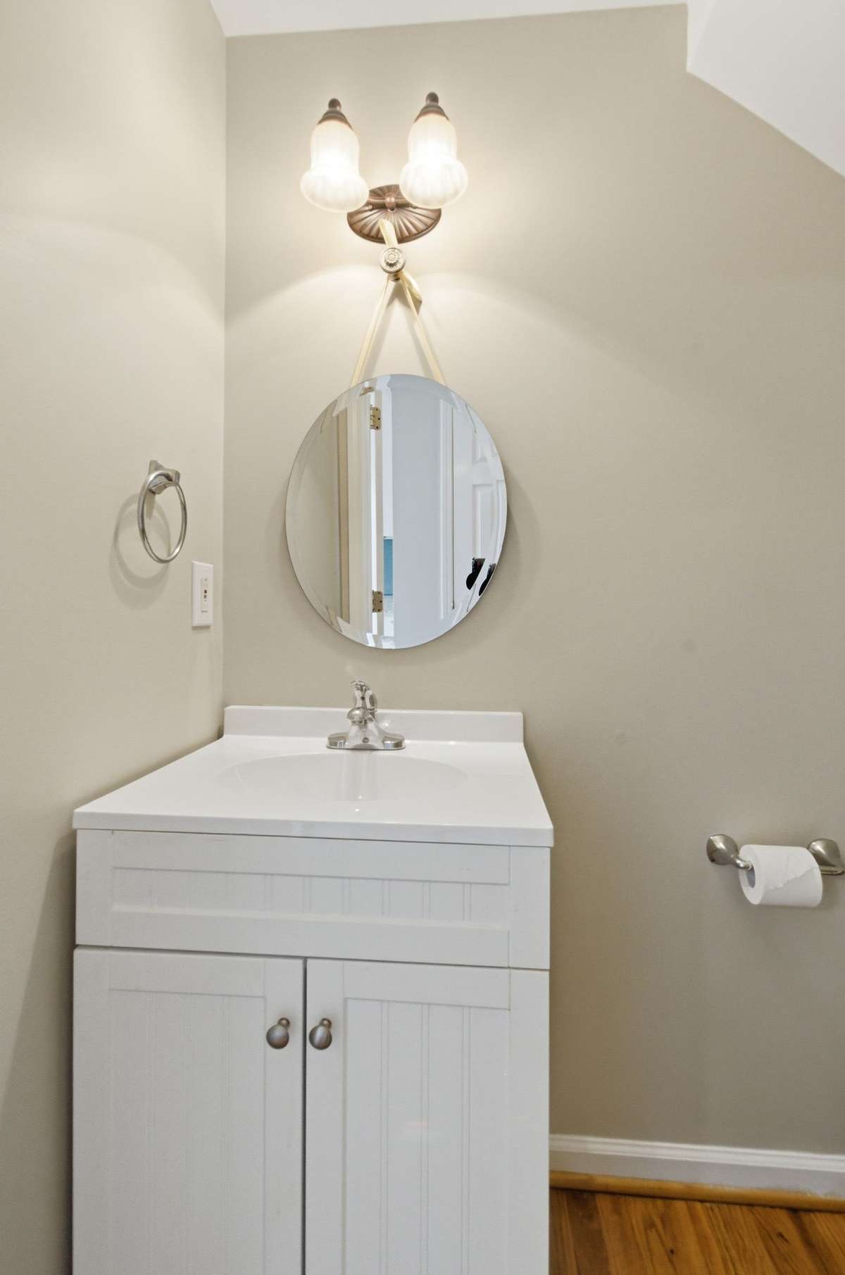 Convenient main-level powder room with a modern vanity, updated lighting, and neutral finishes.