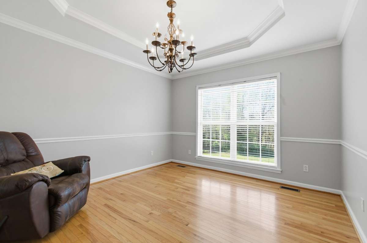 Bright and spacious dining area with hardwood flooring and classic trim details, perfect for hosting gatherings.