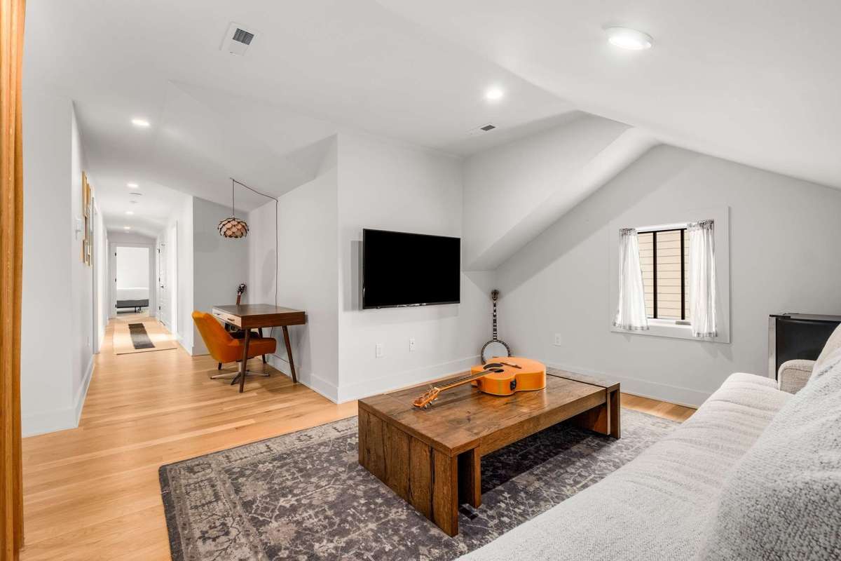 alternate view of upstairs bonus room space, with cove for desk or other uses (peloton!)