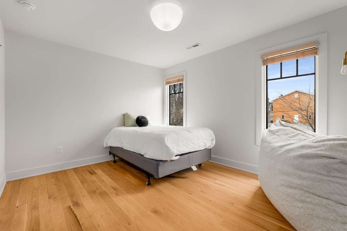 Upstairs secondary bedroom #3, dual windows, hardwood floors and overhead lighting
