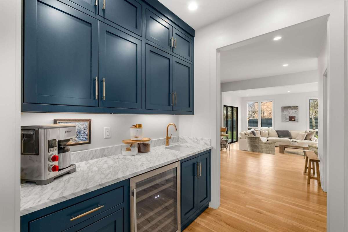 The wet bar and coffee area adjoins the formal dining space and kitchen / main living room.  Note the extra beverage sink, beverage refrigerator, designer cabinets to the ceiling, and under-cab lighting to trim out this beautiful space