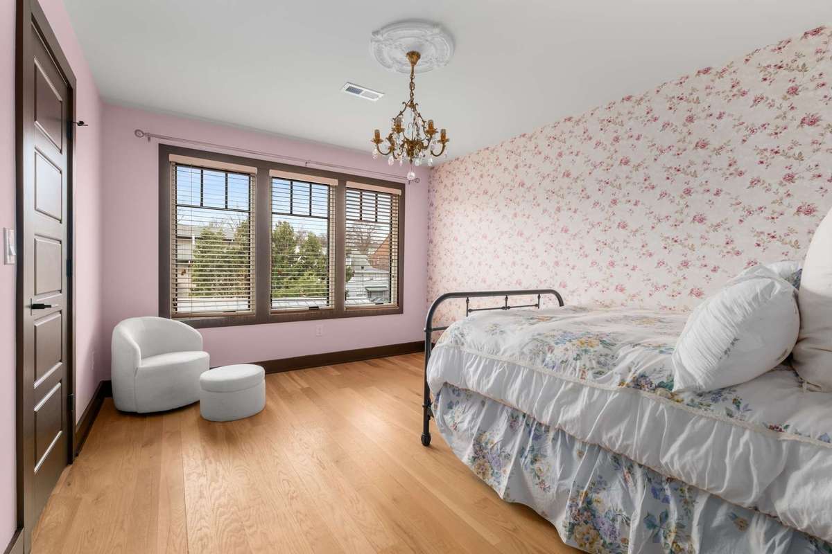 Upstairs secondary bedroom, with direct access to full bath.   Large windows.  All upstairs rooms also feature hardwood flooring