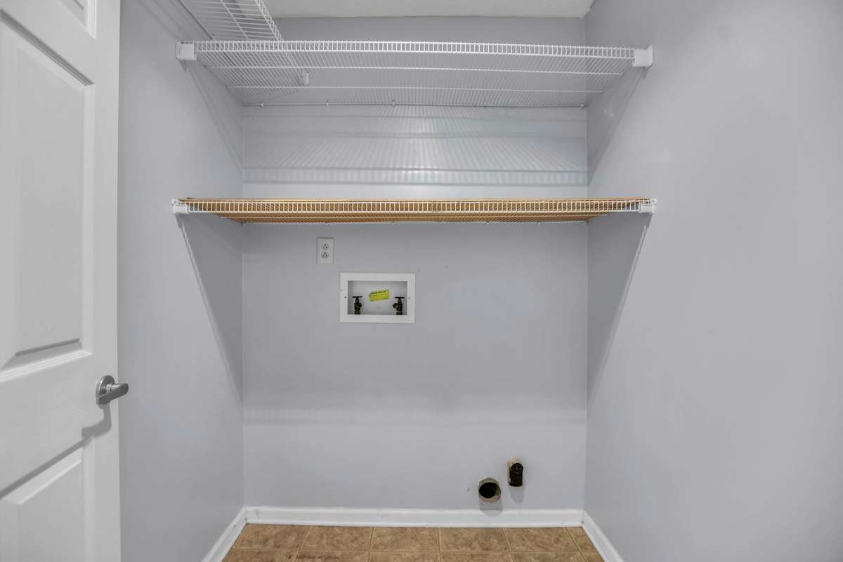 Laundry closet for washer/dryer and overhead shelving for easy storage.