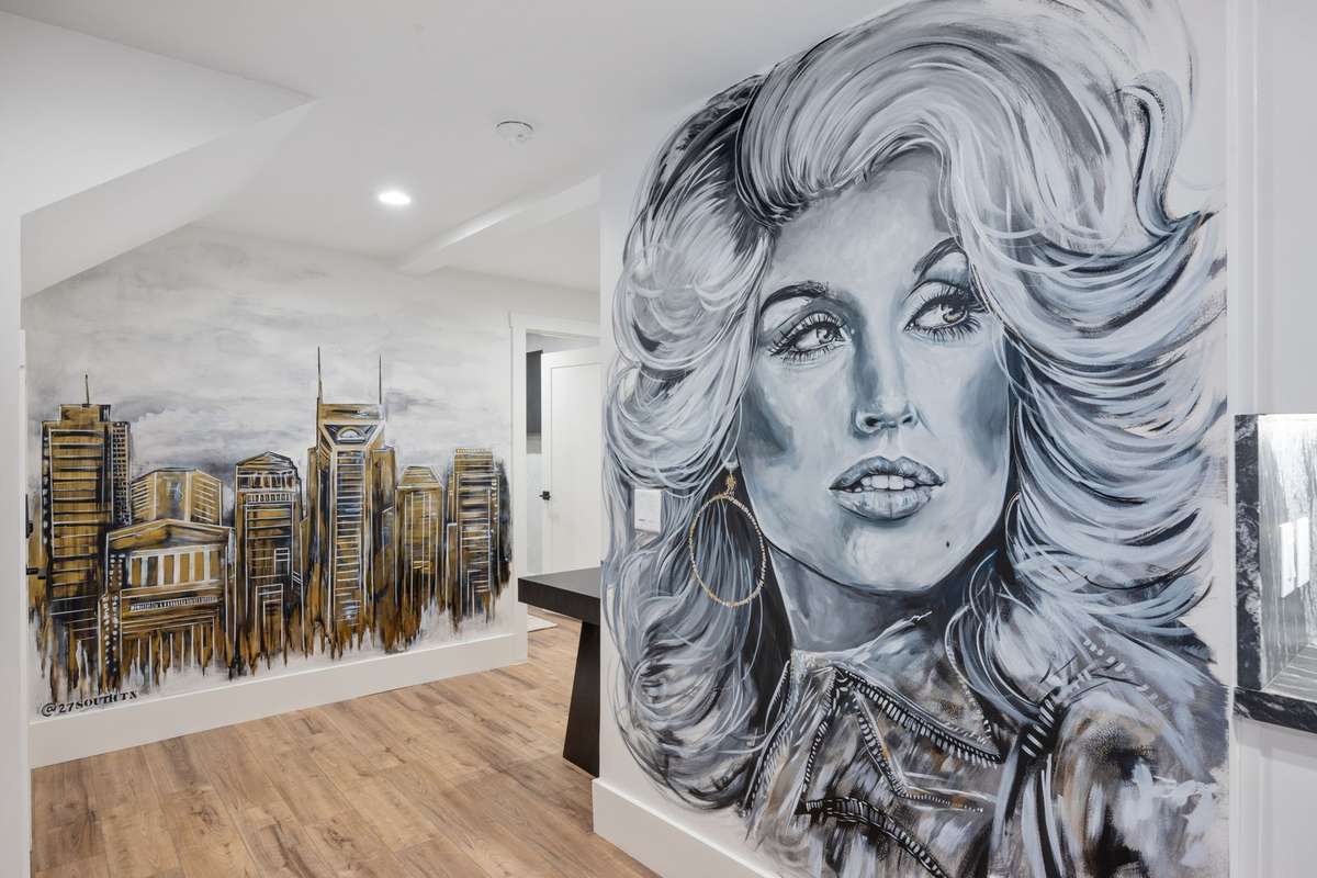 Adding a one-of-a-kind touch, a hand-painted mural captures Dolly Parton and the Nashville skyline—making this space truly unforgettable.