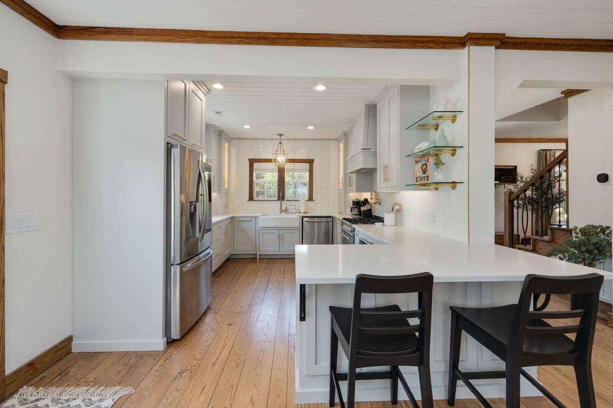 The heart of the home, the kitchen, is thoughtfully updated with stainless steel appliances, abundant counter space, and a seamless flow into the dining room and family room, anchored by a cozy gas fireplace.
