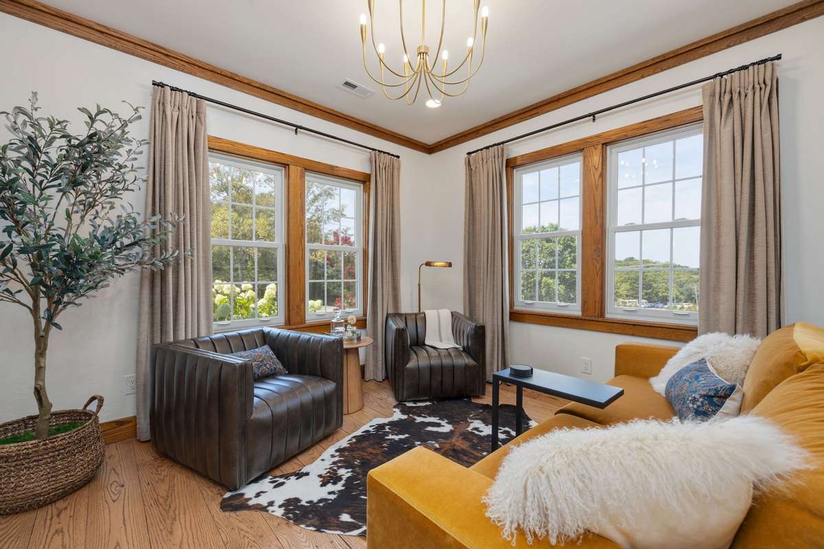 Step through the front door into a warm, inviting foyer that opens to a formal living room or sitting area—perfect for quiet mornings with coffee or lively conversation with friends.