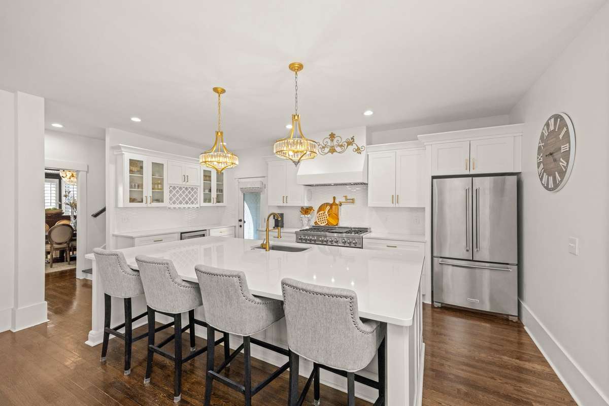 Primary Kitchen. Large Island. Quartz Countertops. Double Gas Oven/Range. 2 Pantries. Additional Eat-In Kitchen Area. SS Appliances.