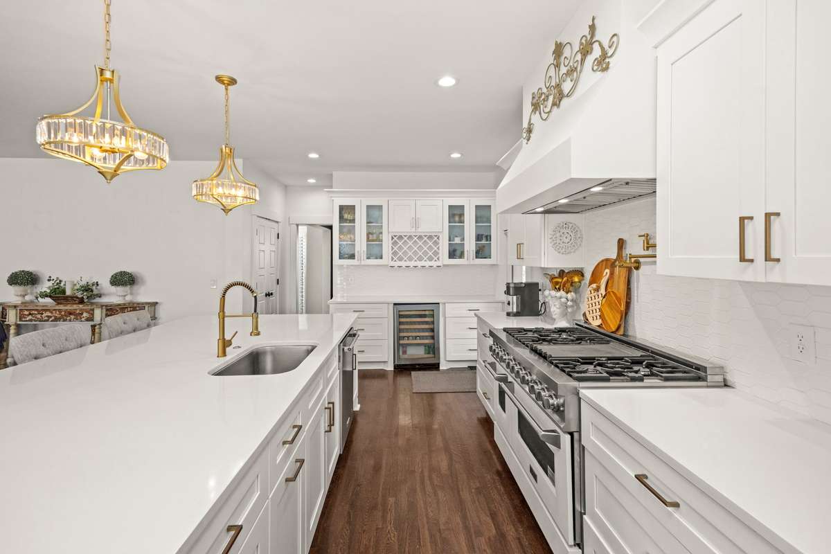Primary Kitchen. Large Island. Quartz Countertops. Double Gas Oven/Range. 2 Pantries. Additional Eat-In Kitchen Area. SS Appliances.