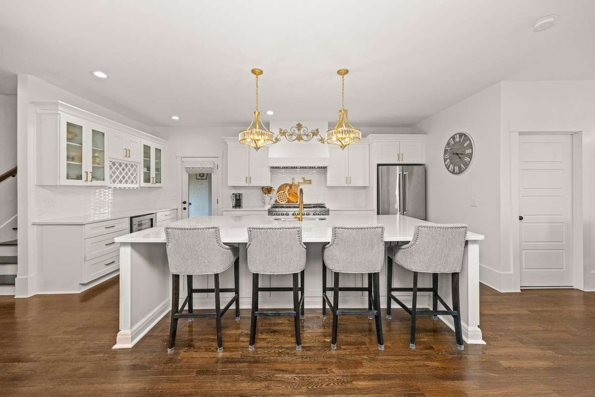 Primary Kitchen. Large Island. Quartz Countertops. Double Gas Oven/Range. 2 Pantries. Additional Eat-In Kitchen Area. SS Appliances.