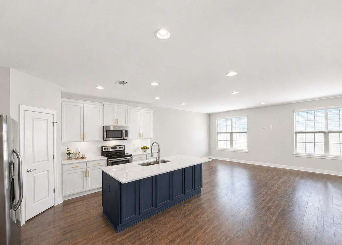 Expansive island and bright, open kitchen create a seamless space for cooking, dining, and connection. (AI rendering based on previously built home)
