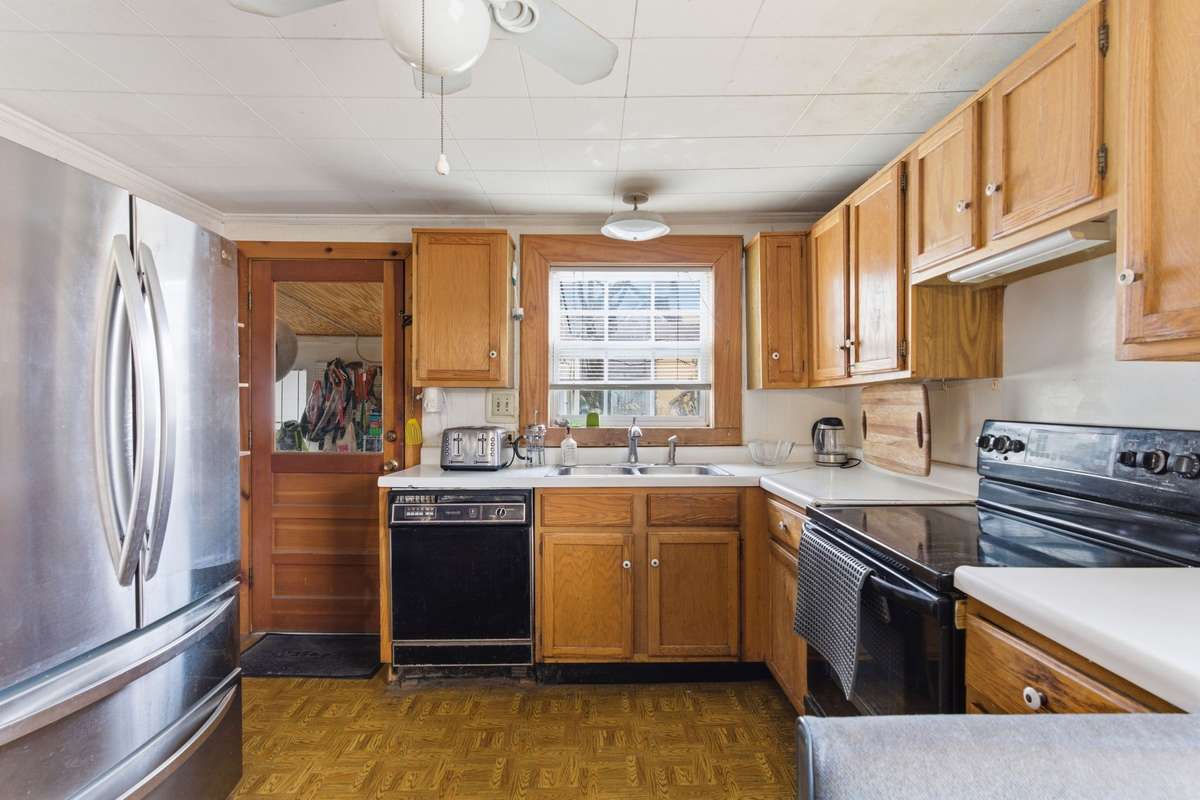A view of the kitchen. The back door leads to the laundry room/mudroom.