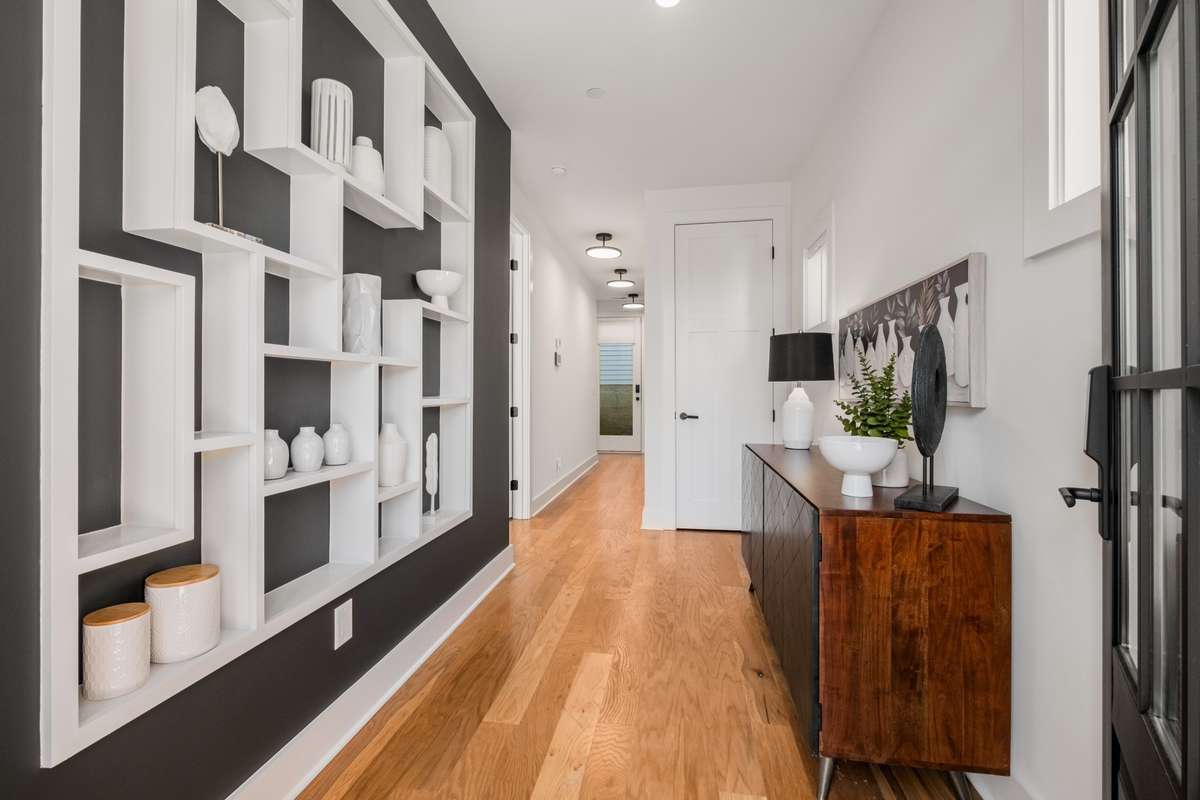 The chic entry foyer beacons you inside, where modern design meets meticulous attention to detail, setting the tone for the rest of the home.