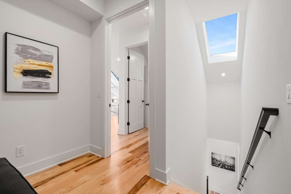 On the third floor of the home, you'll find tons of natural light, a second primary bedroom with ensuite bathroom, a second workspace, plenty of storage, and a second full-size washer/dryer hookup.