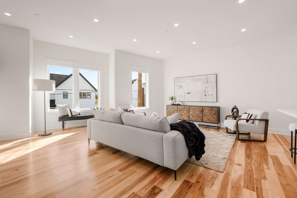 Bathed in natural light and featuring 10 ft ceilings, the home's living room offers flexibility in layout for multiple seating areas or even the possibility of a murphy bed for overnight guests.
