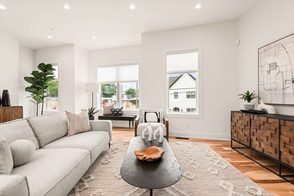 Charming details shine in each sunlit corner, from the seating nook by the windows to the main gathering space.