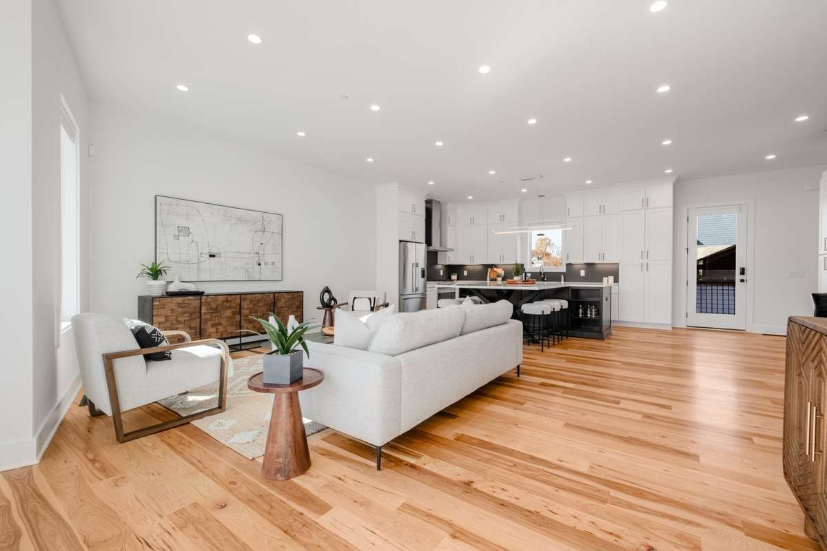 The open-concept design effortlessly blends the living room with the kitchen and dining areas, ideal for entertaining and everyday convenience.