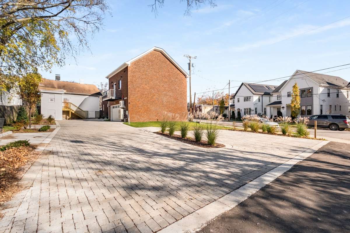 The thoughtfully designed, bricked entry to the back of the townhomes is landscaped and offers additional parking behind your garage.