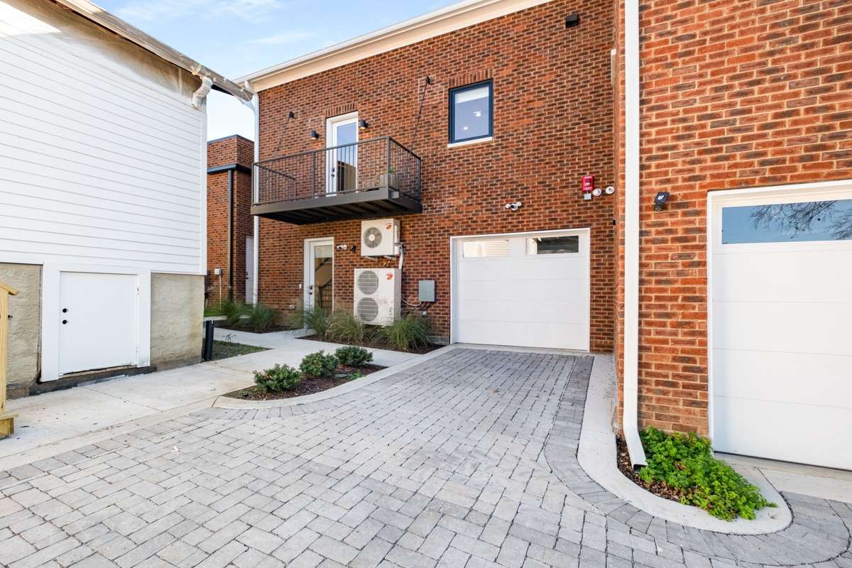 The back entry, garage, parking, and balcony of unit A