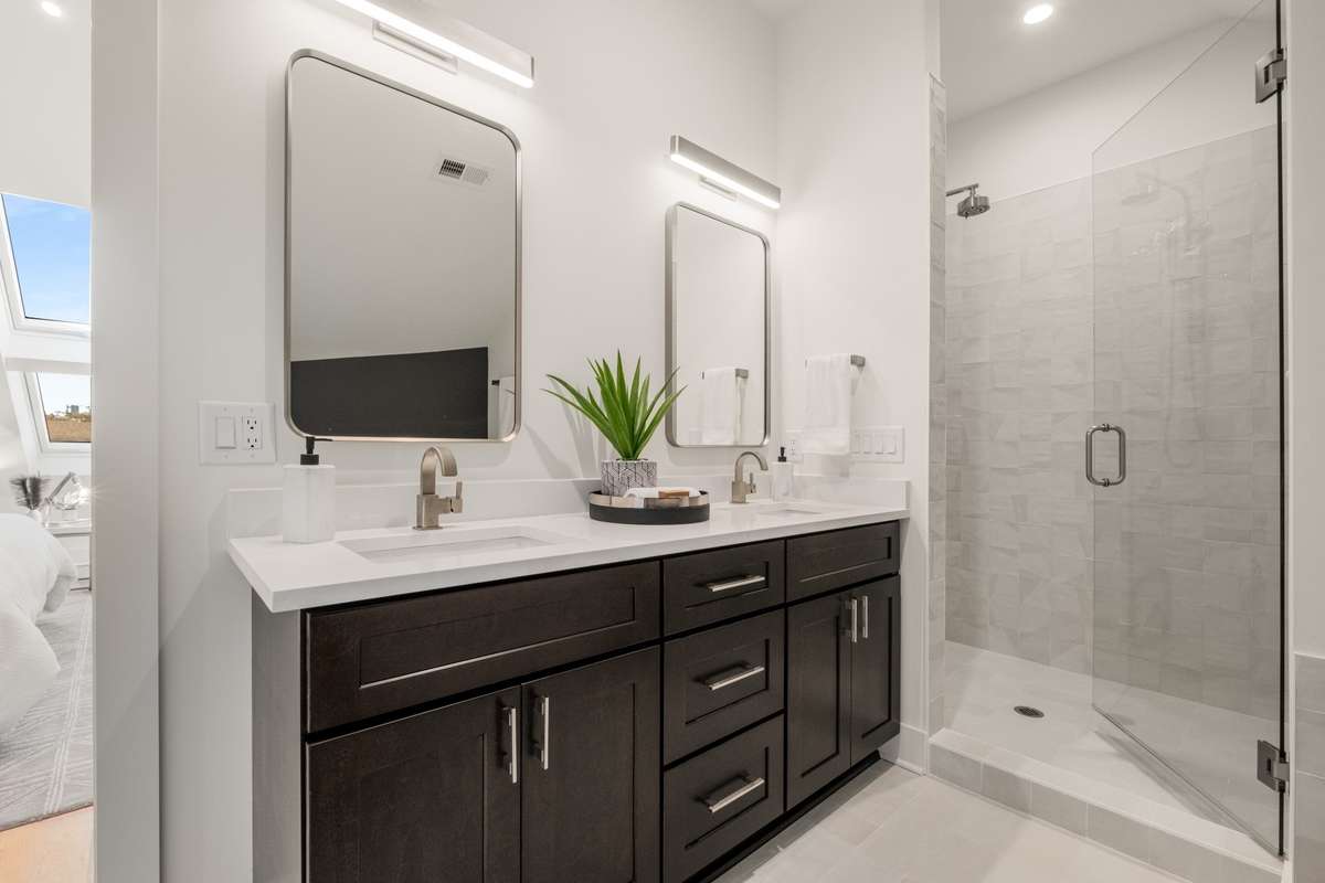 Sleek and understated, this bathroom has everything you need and features a fully enclosed shower with a glass door.