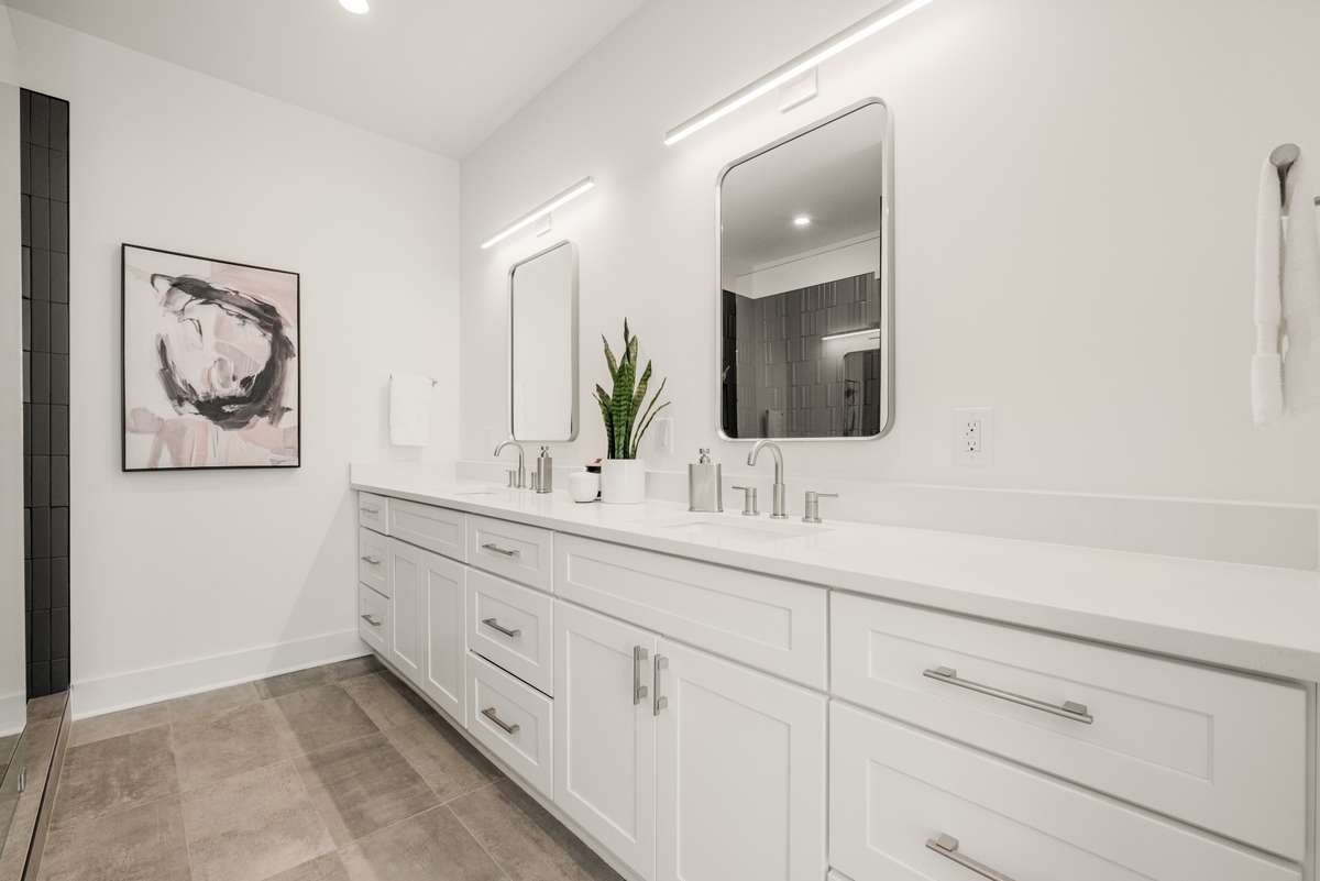With dual vanities, soft close drawers, and a stunning tiled shower, this bathroom is as luxurious as it is beautiful.