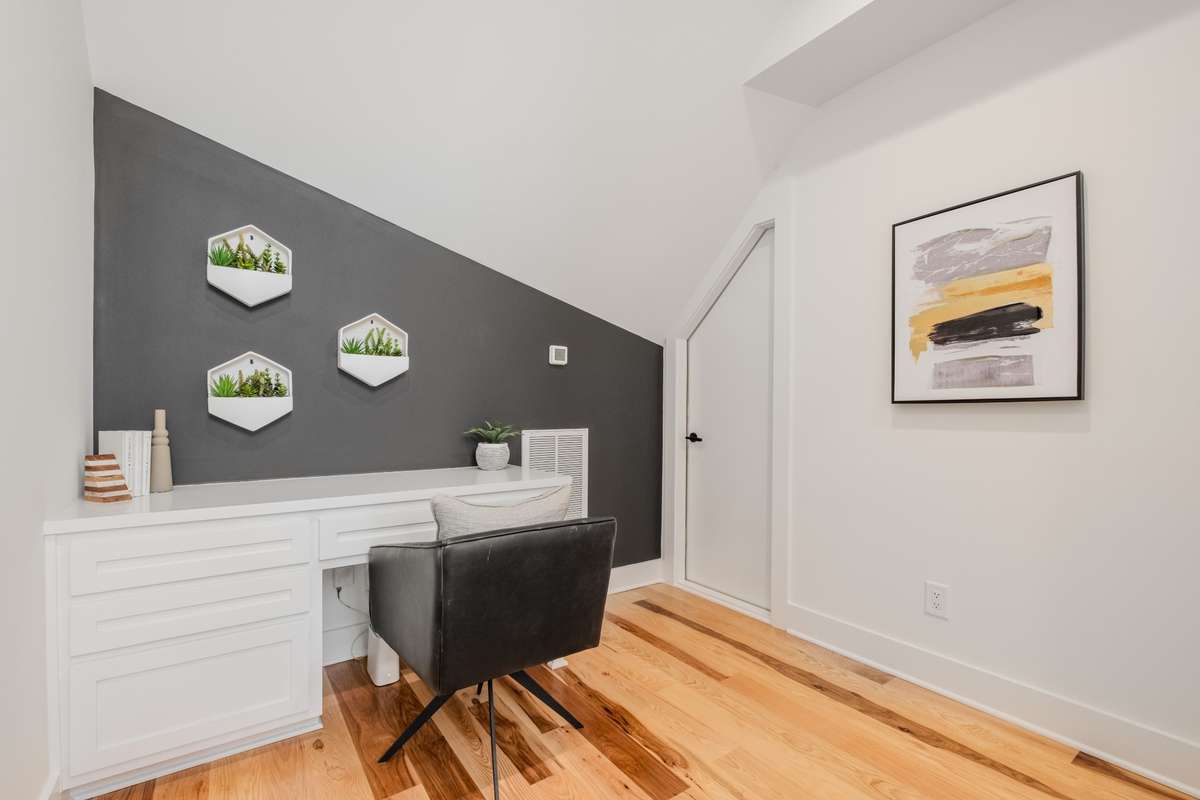 This cozy, private built-in workstation is ideal for a second work-from-home space. And don't miss the attic storage!