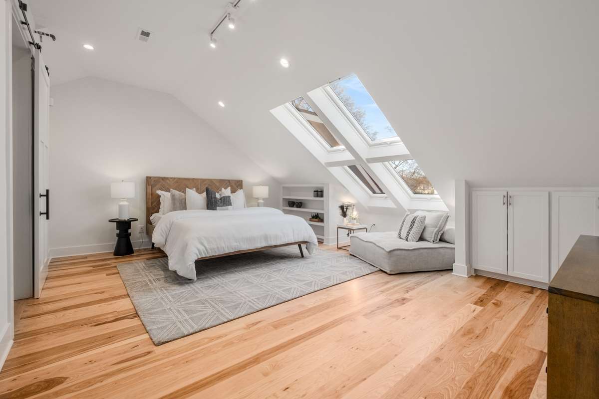 The third-floor primary bedroom is both inviting and cozy in its design, with plenty of built-in storage.
