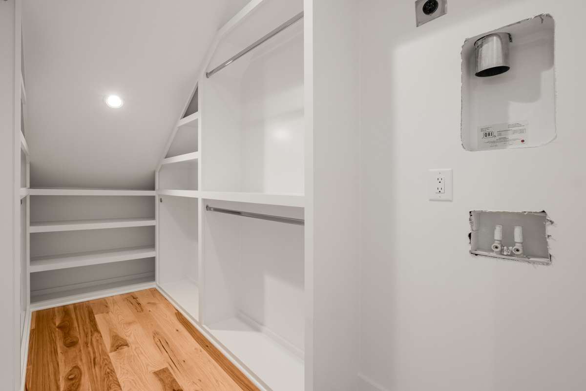 The large, walk-in primary closet is also designed to host a full-sized washer and dryer.