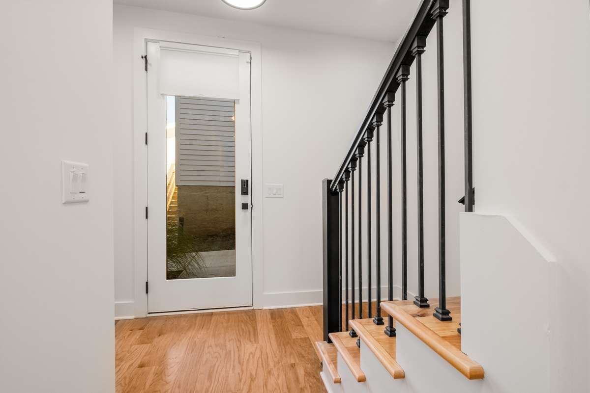 The ground floor of the home also offers access to the garage and outside to the back of the home and parking pad.
