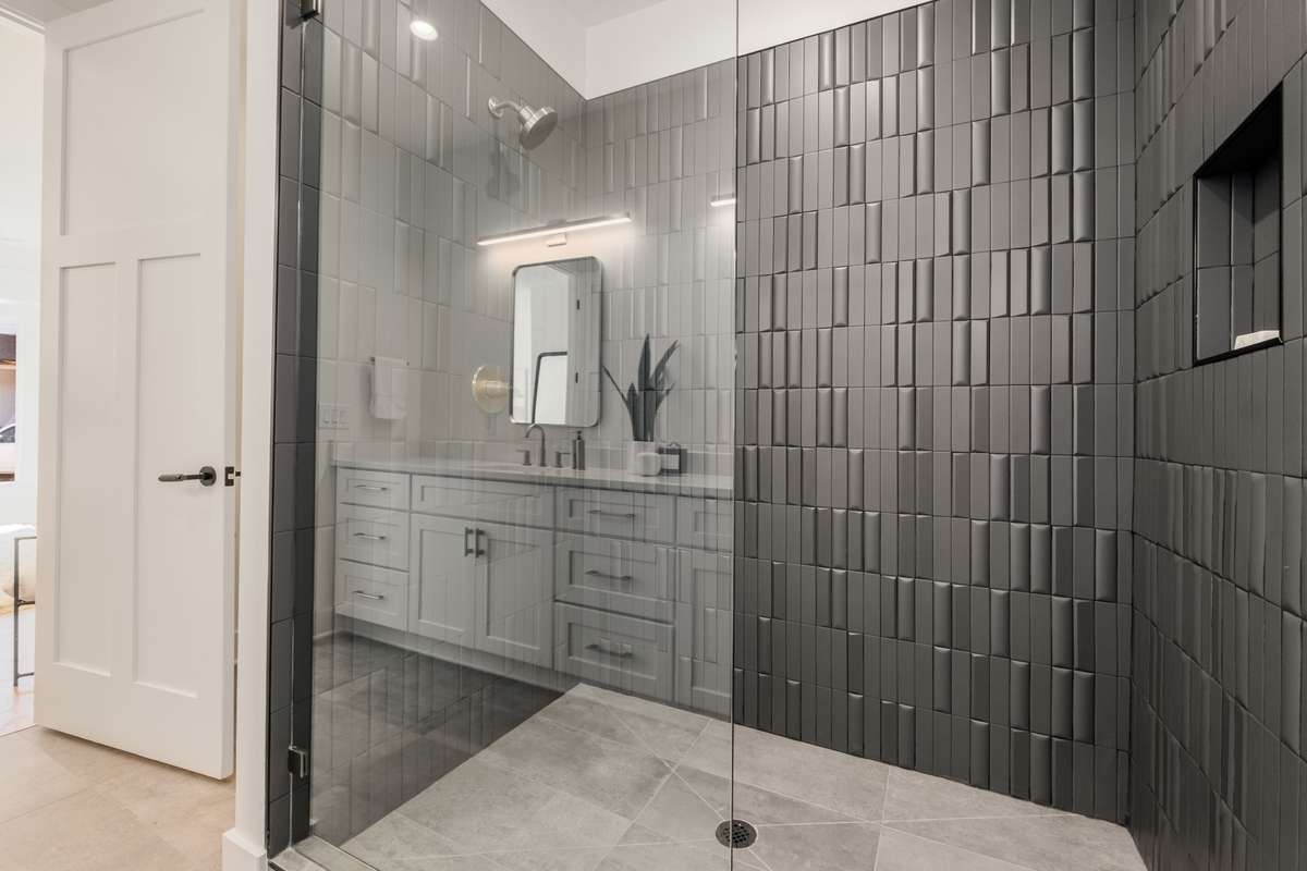 The gorgeous tile work in this generously sized shower evokes a spa-like sense of calm.