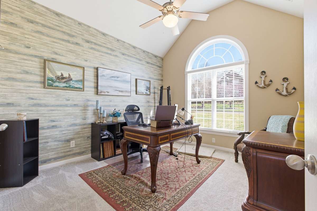 Room is being used as office has a trapdoor with built in ladder that leads to crawlspace with ceilings tall enough to walk comfortably to keep you safe from the storms.