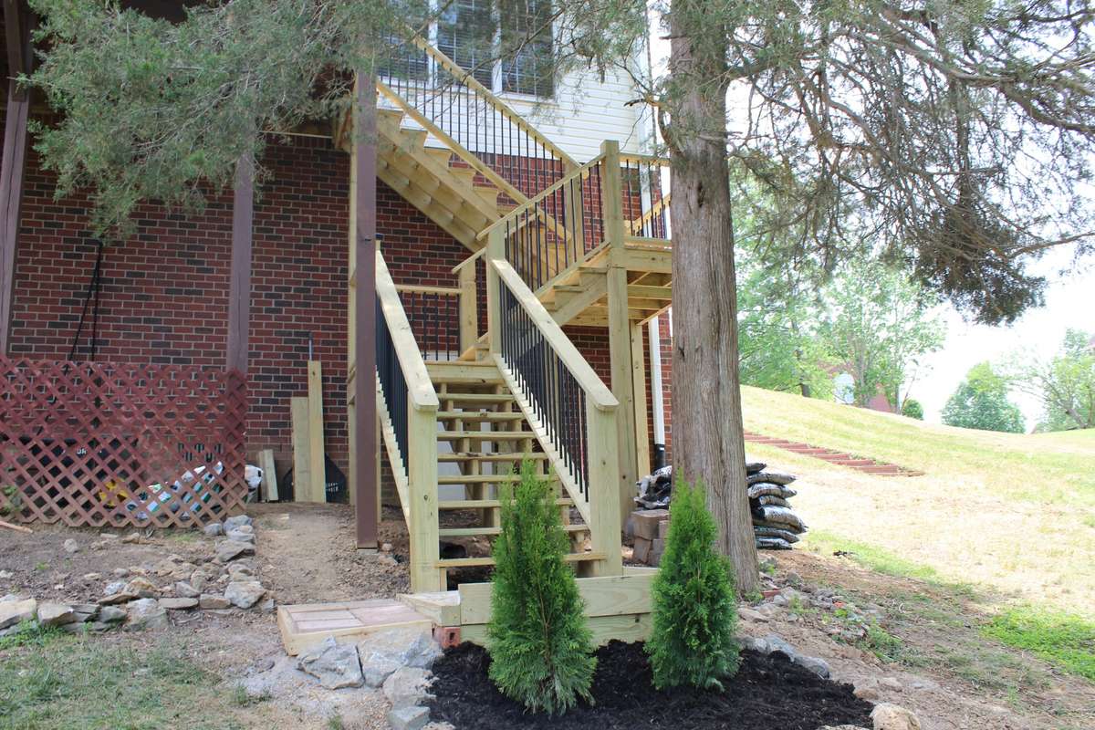 Door to crawlspace is located just behind these new stairs.