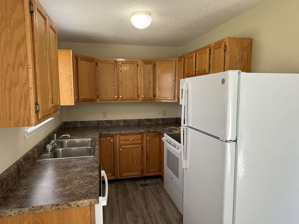 New appliances including over the stove microwave and refrigerator with ice maker