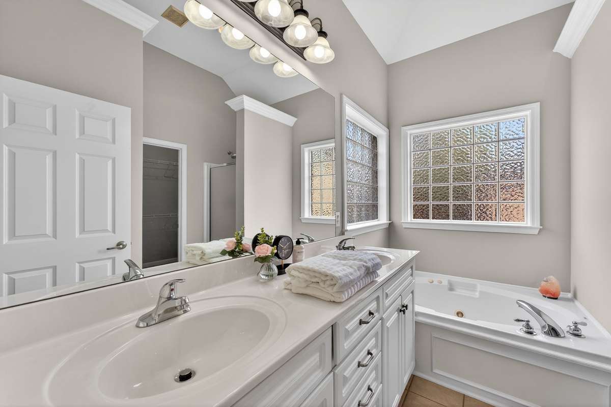 Primary bathroom with, double sinks, jacuzzi tub and large walk in closet.
